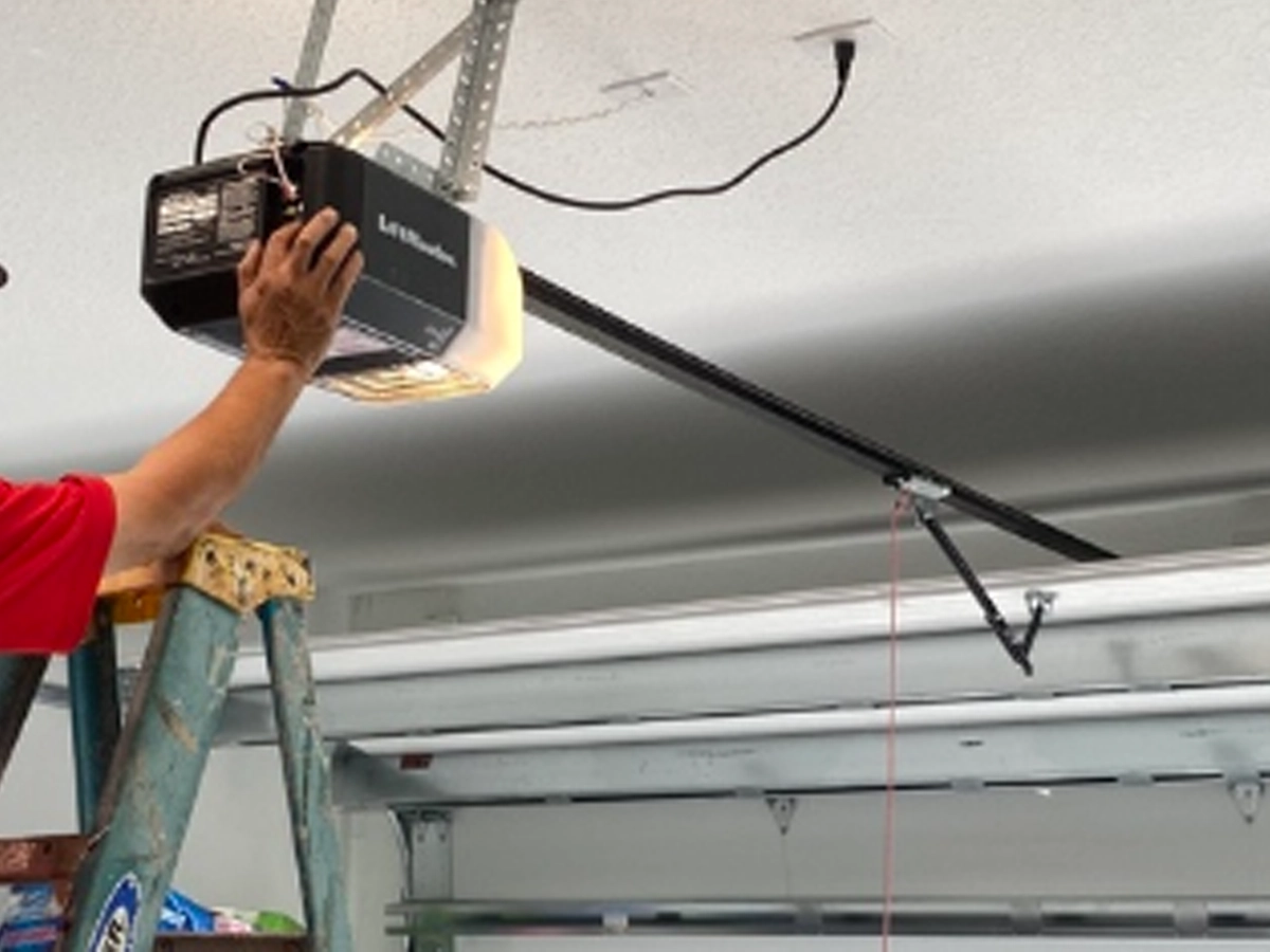 Garage Door Repair in Franklin technician inspecting springs and rollers