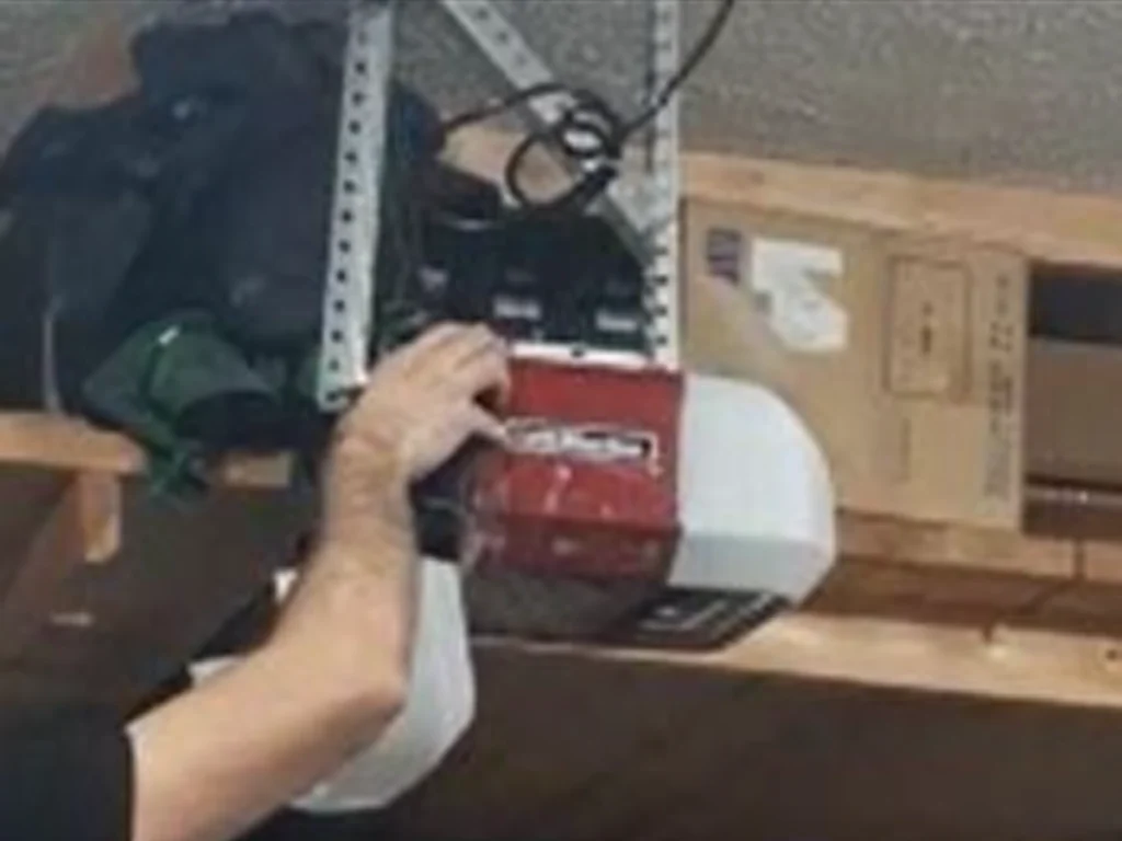 garage door maintenance Franklin TN with a technician checking rollers and safety sensors on a residential door