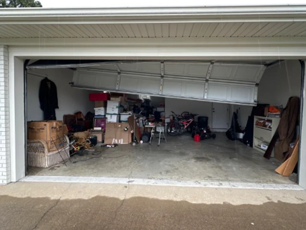 Garage door repair technician inspecting a garage door