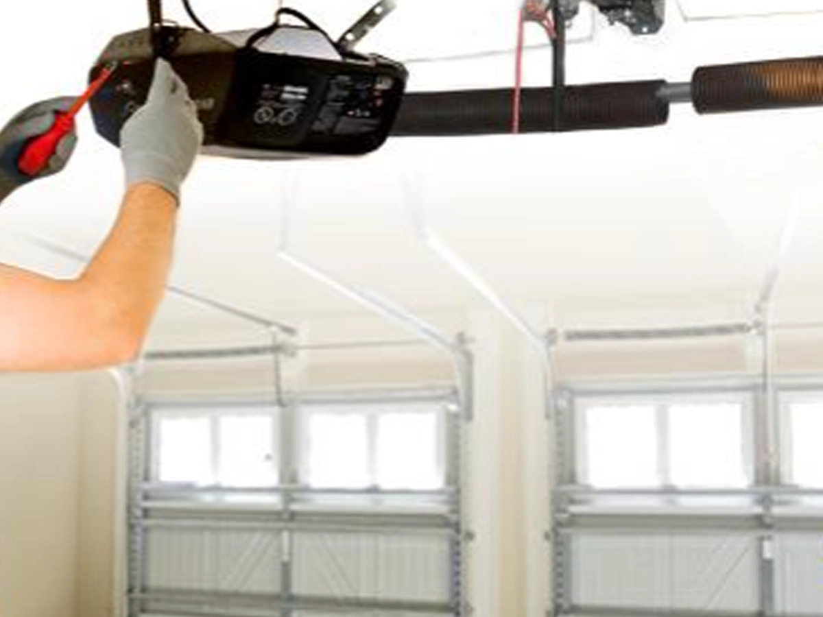 Technician maintaining garage door to keep your garage door working like new