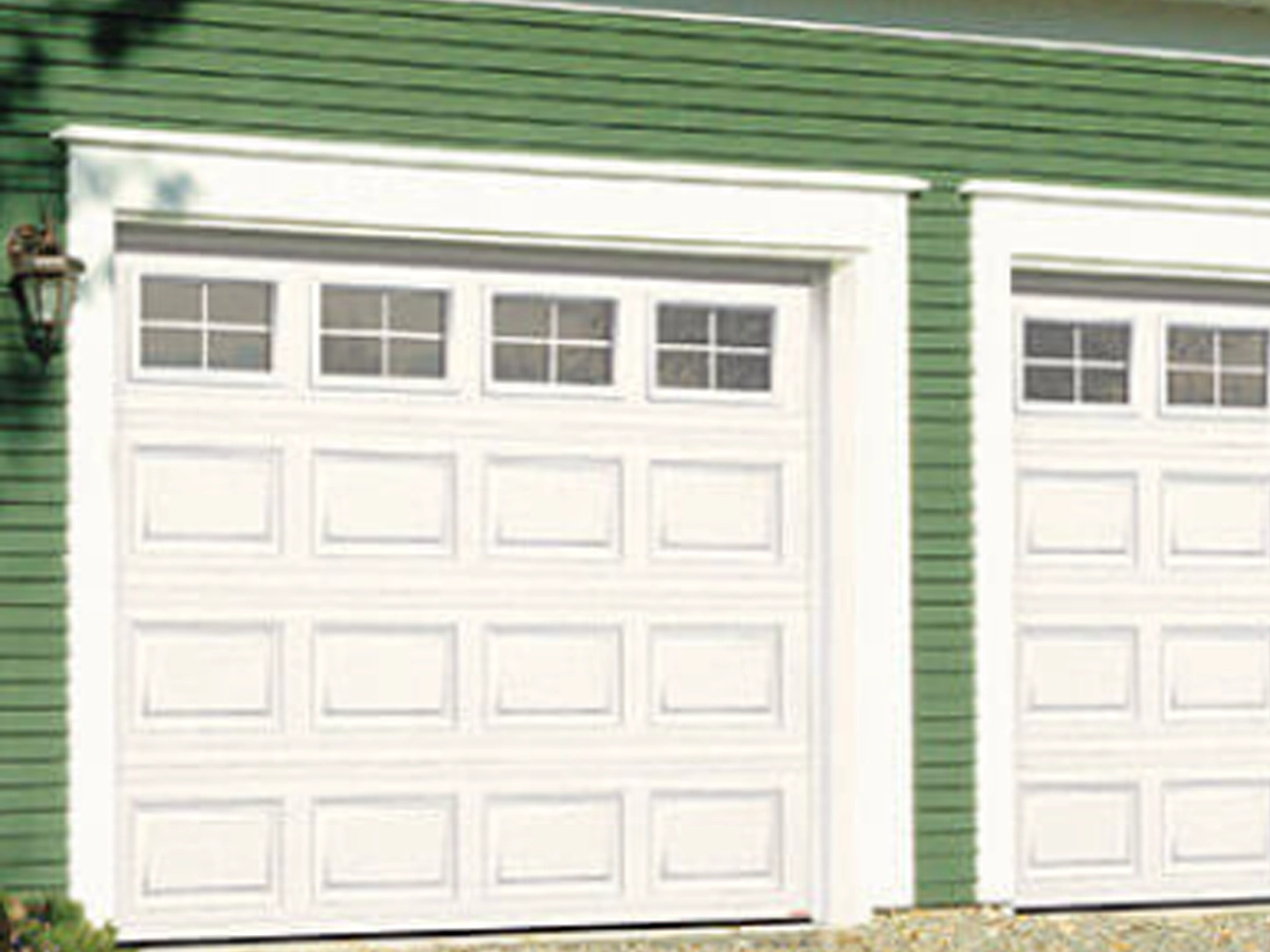 Unique Custom Garage Door Styles Franklin on a beautiful home with modern panels, windows, and clean curb appeal