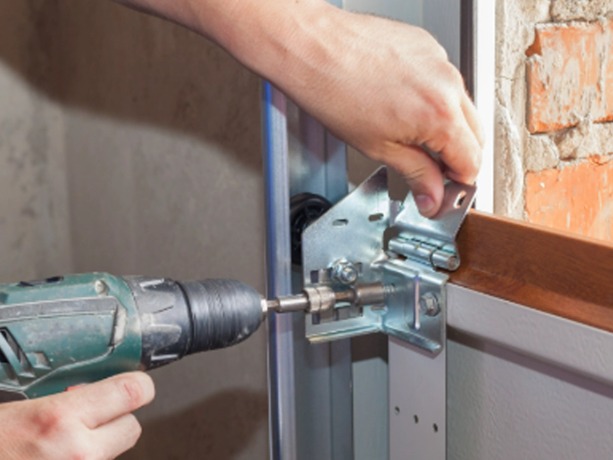 rgent Garage Door Repairs in Franklin by Everlast Garage Doors technician checking a stuck garage door