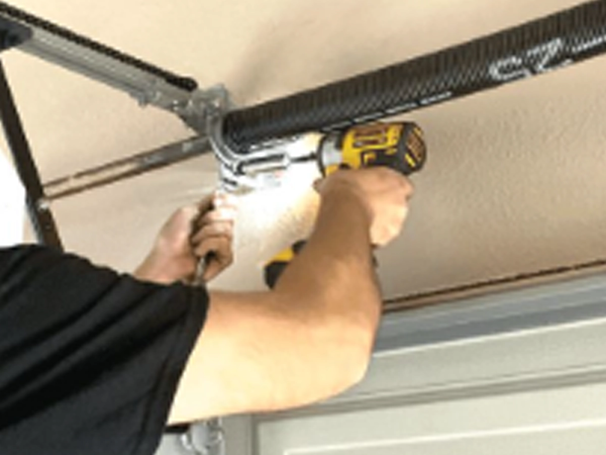 Technician testing improved garage door parts on a balanced sectional door in Franklin, Tennessee