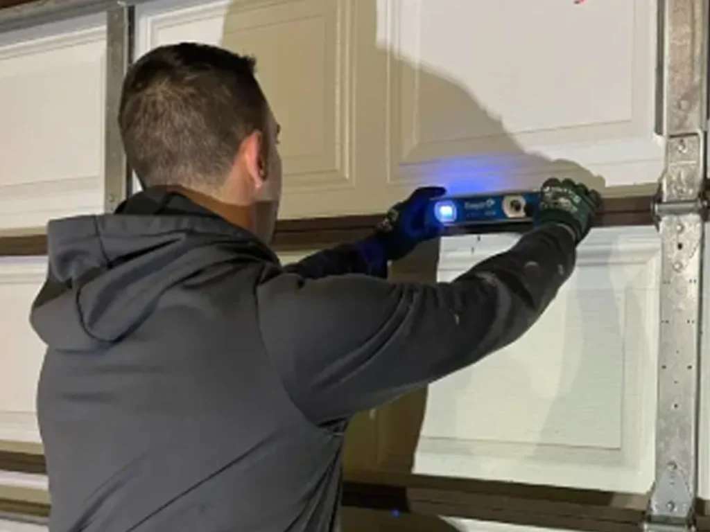 Why your residential garage door is making strange noises as a Franklin technician checks rollers, hinges, springs, tracks, and opener parts.